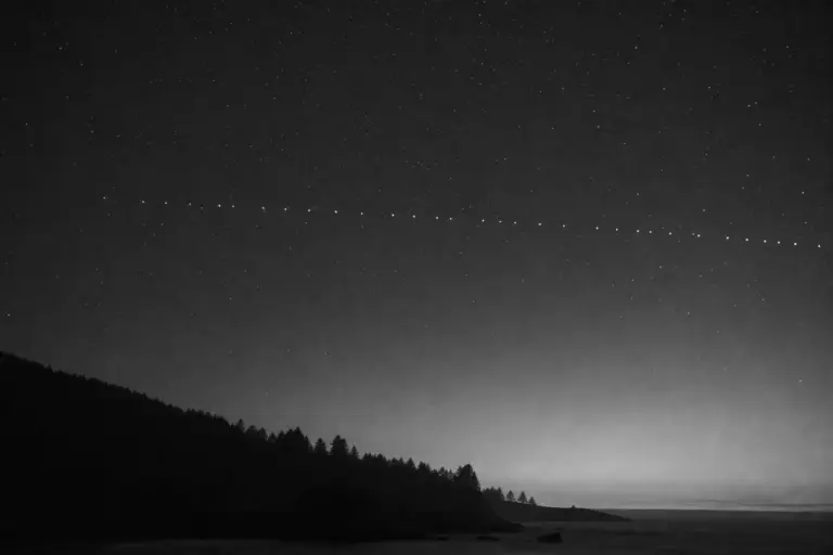 Satellite Train Above the Coast