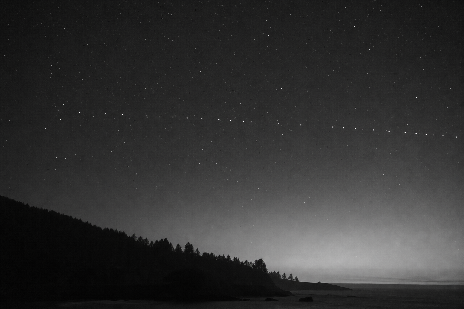 Satellite Train Above the Coast