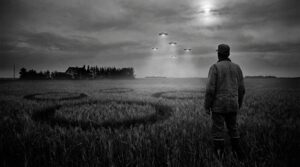 Farmer watching five UFOs over field