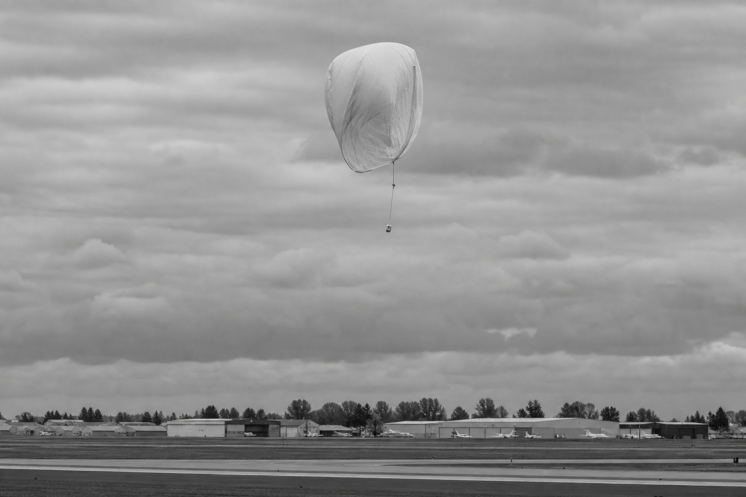 Deflating Weather Balloon in Open Sky